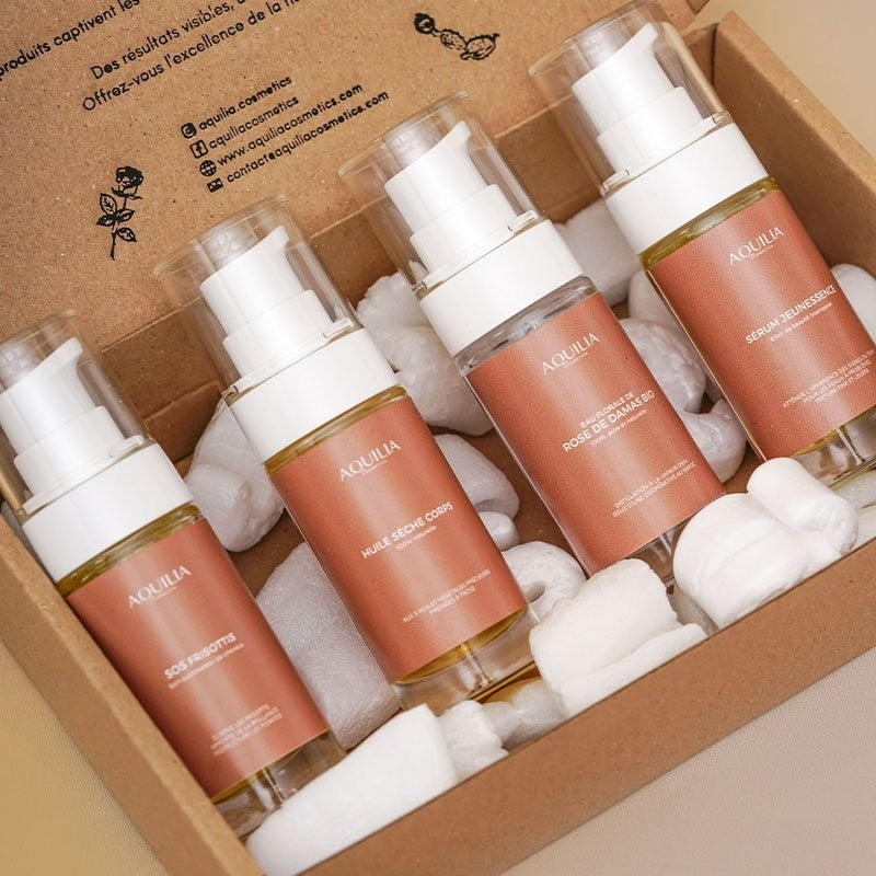 Coffret découverte Aquilia Cosmetics avec 4 flacons de soins : SOS frisottis, huile sèche corps, eau florale de rose de damas bio et sérum jeunessen.ce